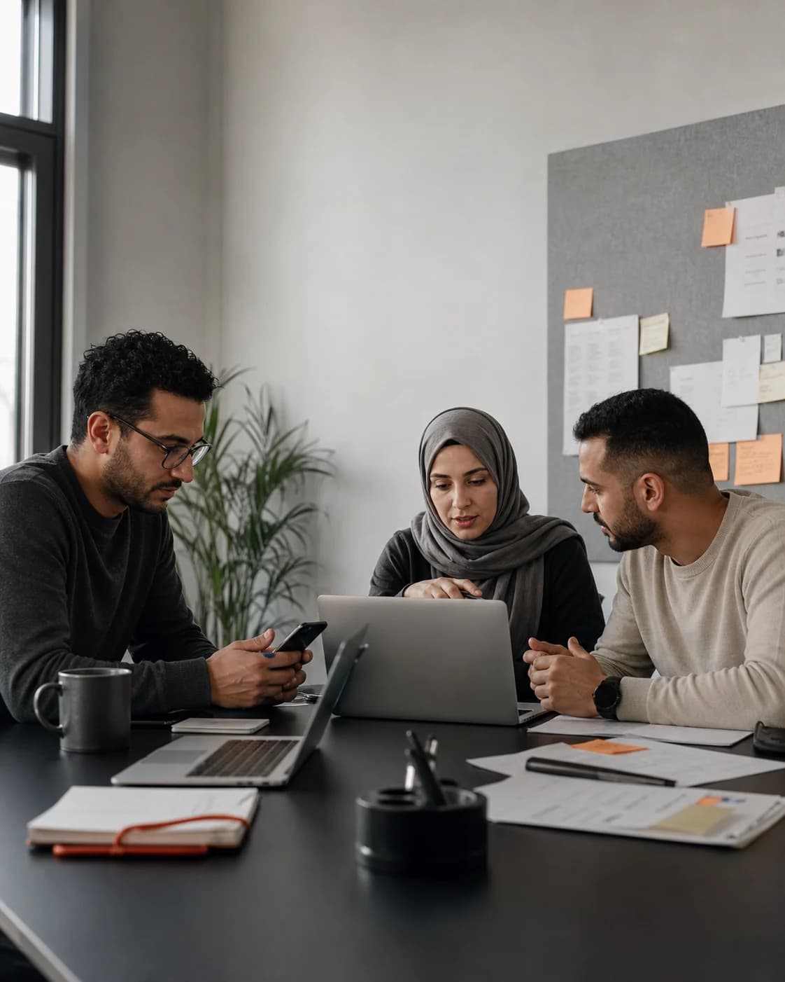 A customer operations team coordinating messaging and follow-up around a shared workspace